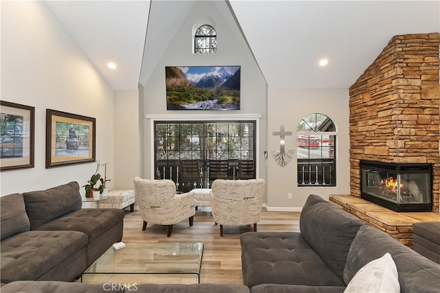 living room with high vaulted ceiling, recessed lighting, a fireplace, wood finished floors, and baseboards