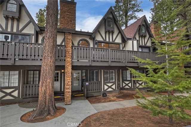 exterior space featuring a chimney and stucco siding