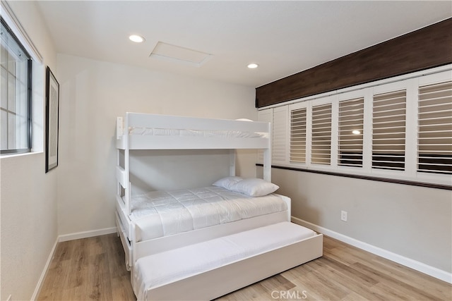 bedroom featuring recessed lighting, wood finished floors, and baseboards