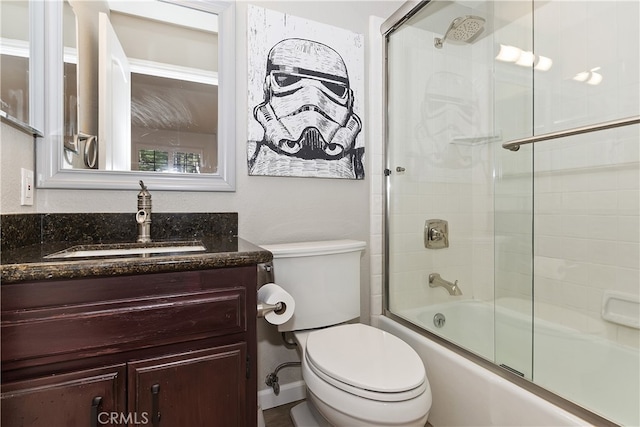 full bathroom featuring toilet, vanity, and enclosed tub / shower combo