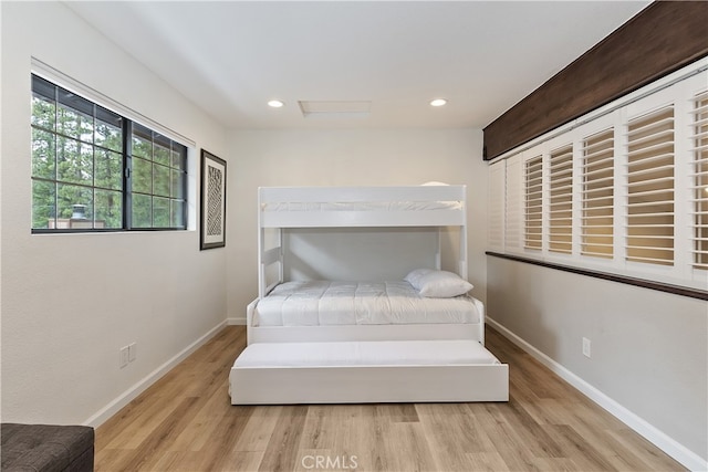 bedroom with recessed lighting, wood finished floors, and baseboards