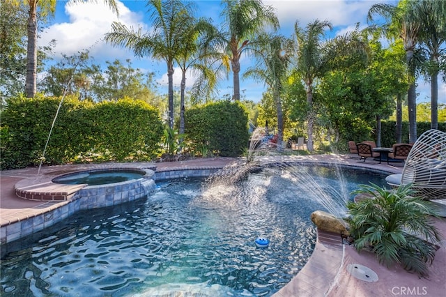 view of pool with a pool with connected hot tub