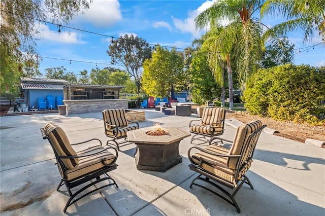 view of patio / terrace with an outdoor living space with a fire pit