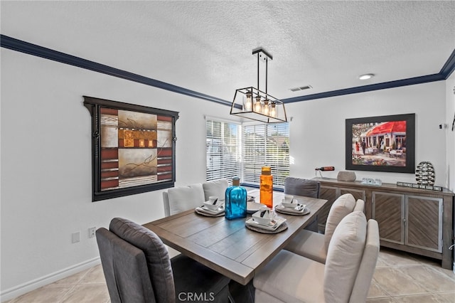 dining space with visible vents, a textured ceiling, crown molding, light tile patterned floors, and baseboards