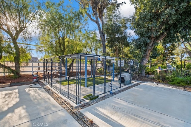 view of community with an outdoor structure and fence