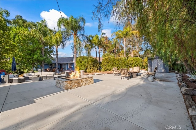 view of patio featuring an outdoor living space with a fire pit