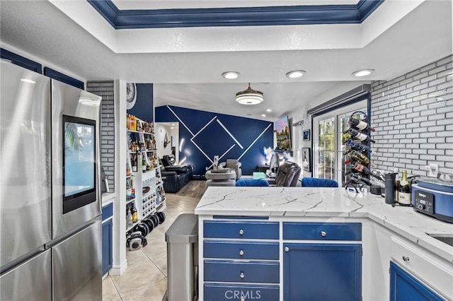 kitchen with blue cabinets, smart refrigerator, open floor plan, a peninsula, and light tile patterned floors