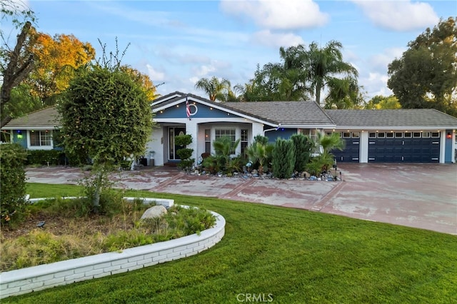 view of front of property with a front yard, an attached garage, and driveway