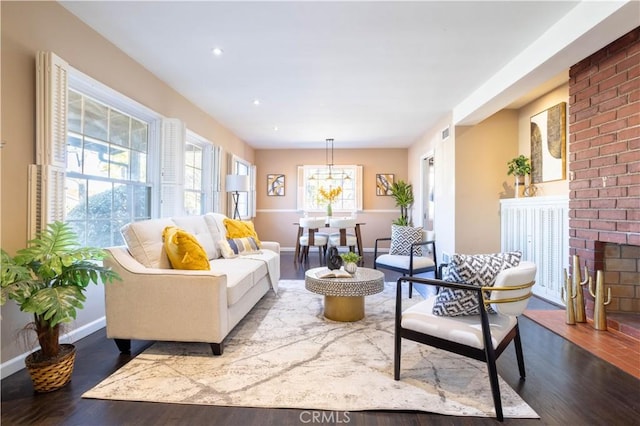 living room with recessed lighting, a fireplace, wood finished floors, and baseboards