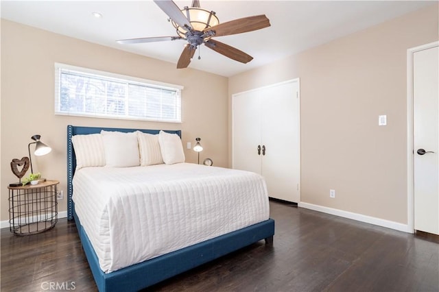 bedroom featuring ceiling fan, baseboards, and wood finished floors