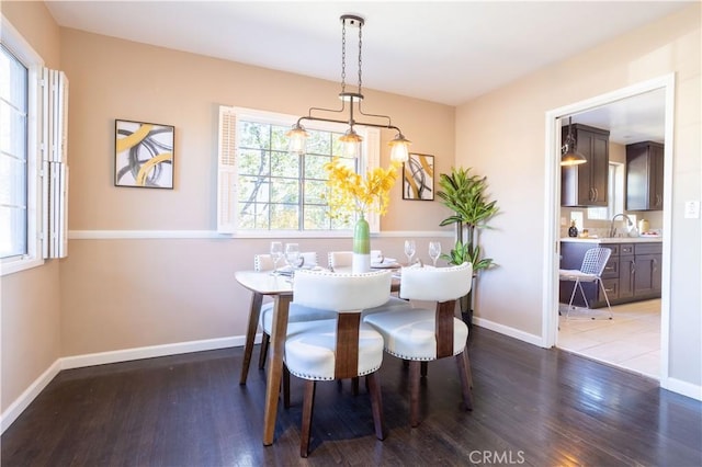 dining area featuring wood finished floors and baseboards