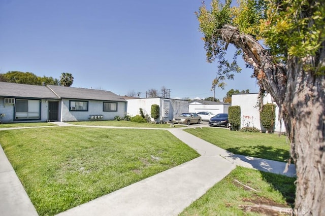 view of front facade with stucco siding and a front yard