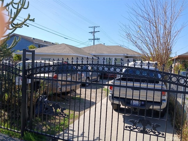 view of gate with a fenced front yard