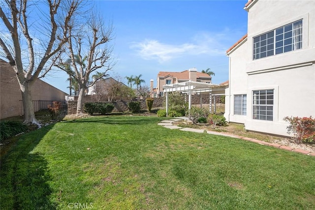 view of yard featuring fence and a pergola