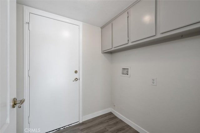 laundry room featuring washer hookup, dark wood finished floors, cabinet space, and baseboards