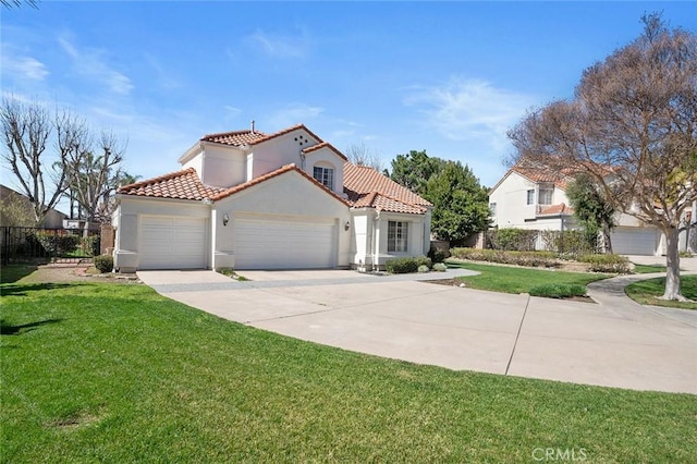 mediterranean / spanish-style home with a front yard, driveway, an attached garage, and stucco siding