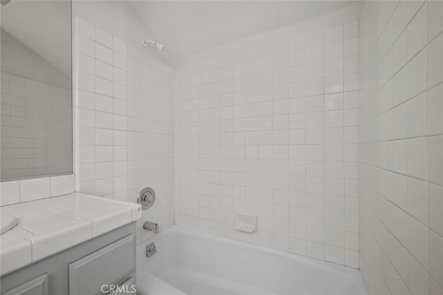 bathroom with bathtub / shower combination and vanity