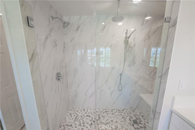 full bath with a marble finish shower