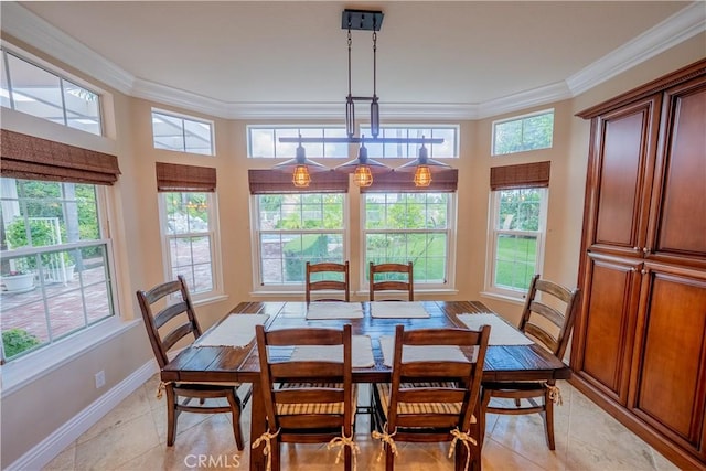 dining room featuring light tile patterned floors, baseboards, and ornamental molding