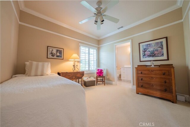 carpeted bedroom with visible vents, connected bathroom, baseboards, and ornamental molding