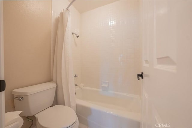 bathroom with toilet and shower / tub combo