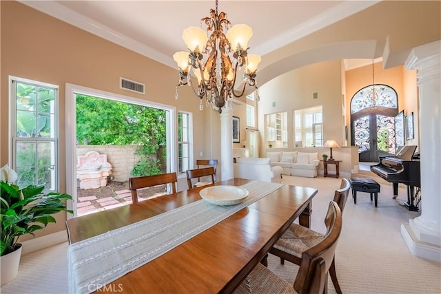 dining space with decorative columns, plenty of natural light, and visible vents