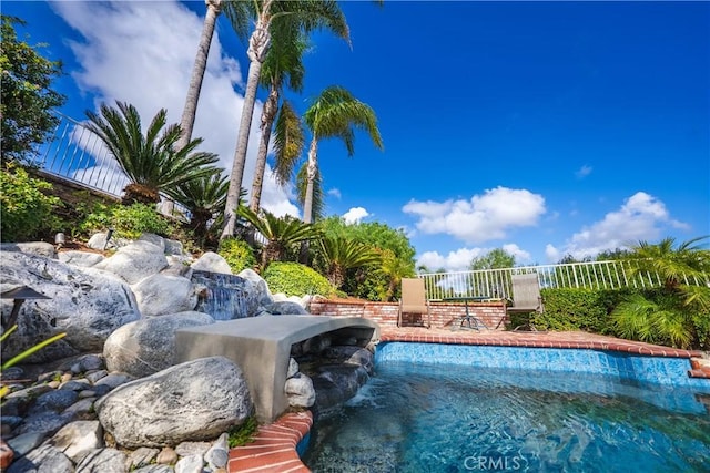 outdoor pool featuring fence