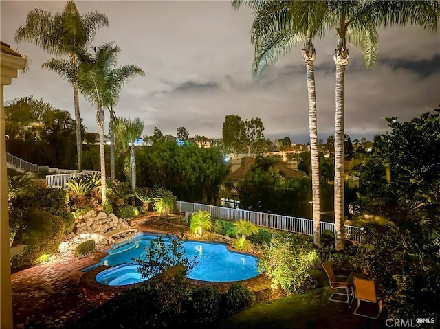 view of swimming pool featuring a jacuzzi and a fenced backyard