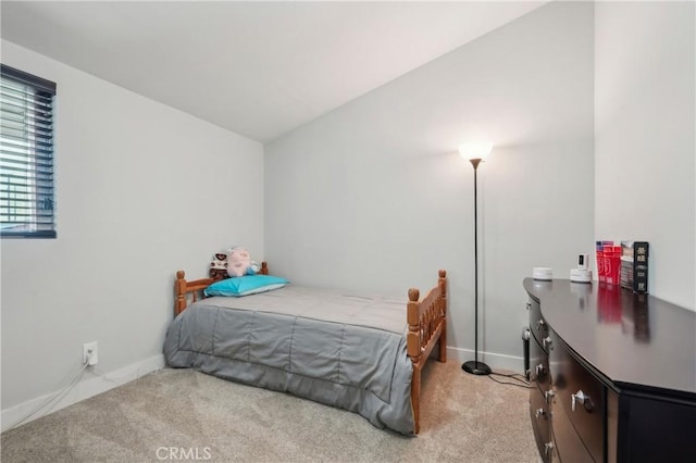 bedroom with baseboards and light colored carpet