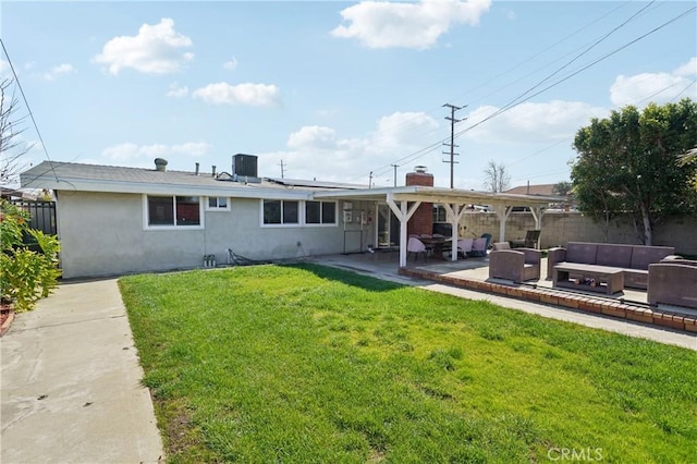 rear view of property featuring a yard, a patio area, central AC, fence, and an outdoor living space