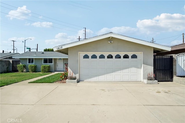 single story home featuring a garage, driveway, and stucco siding