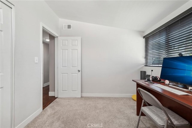 carpeted office space with visible vents and baseboards