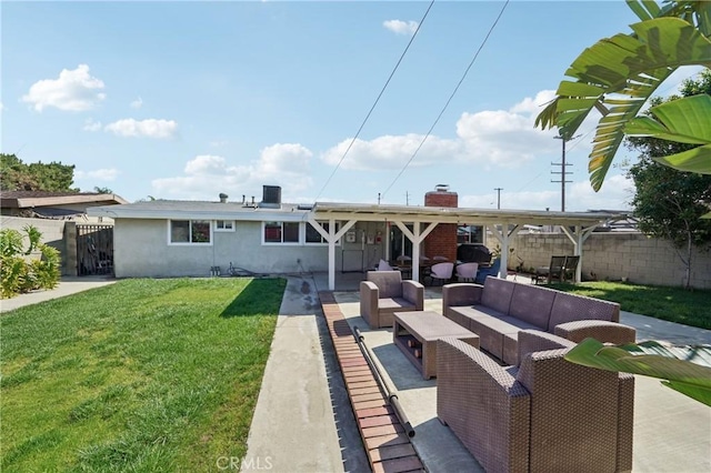 back of property with stucco siding, fence, an outdoor hangout area, and a yard