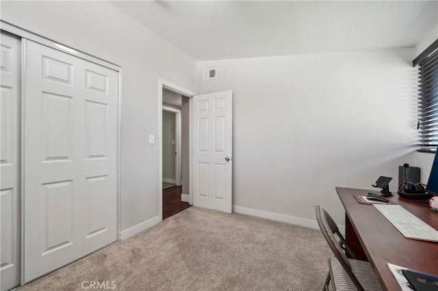 office area with light carpet, baseboards, and visible vents