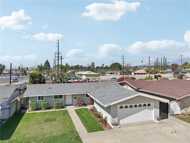 ranch-style home with a garage, a shingled roof, concrete driveway, a front lawn, and stucco siding