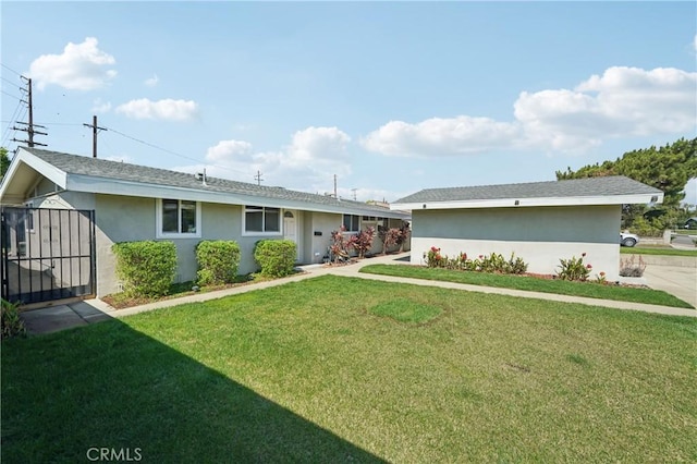 view of front of home featuring a front yard and stucco siding