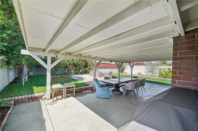 view of patio featuring outdoor dining space, area for grilling, and a fenced backyard