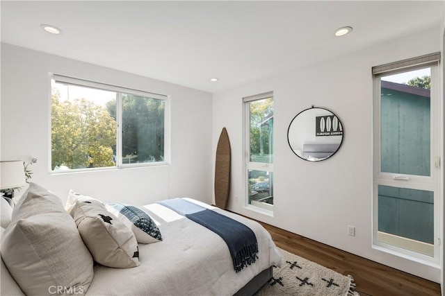 bedroom with recessed lighting and wood finished floors