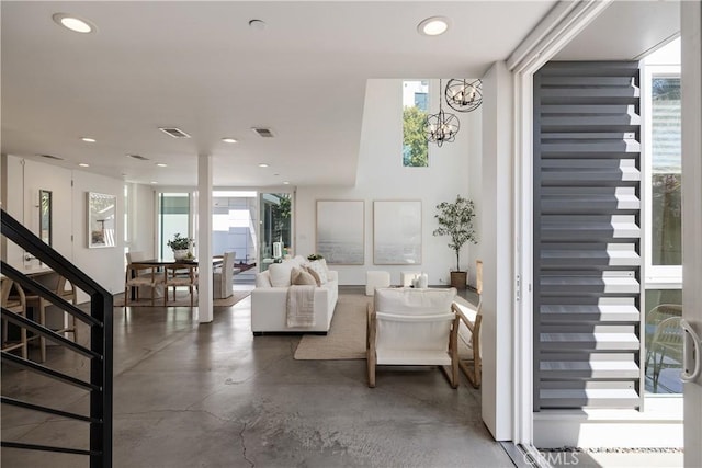 living room with concrete floors, visible vents, and a healthy amount of sunlight