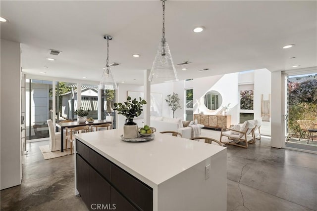 kitchen with recessed lighting, visible vents, light countertops, a center island, and pendant lighting