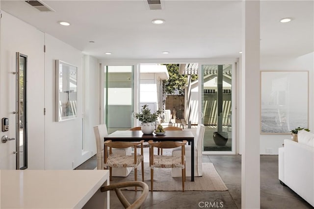 dining area with concrete flooring, recessed lighting, visible vents, and radiator heating unit