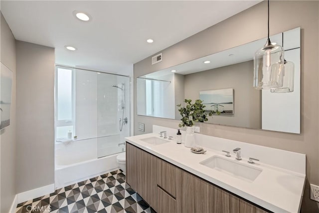 bathroom featuring toilet, visible vents, a sink, and recessed lighting