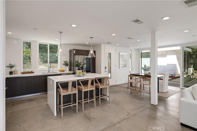 kitchen with visible vents, a sink, smart refrigerator, and modern cabinets