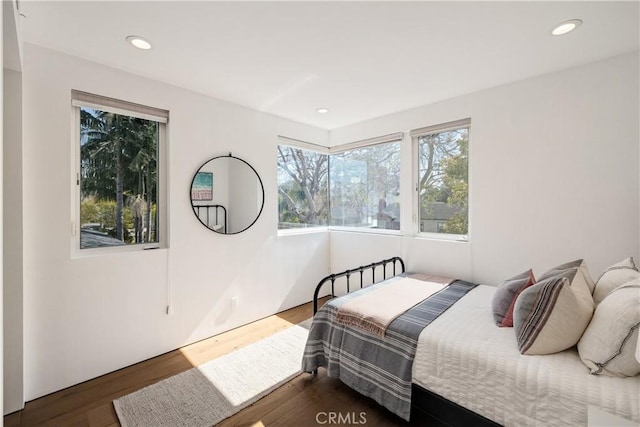 bedroom featuring dark wood-style floors and recessed lighting