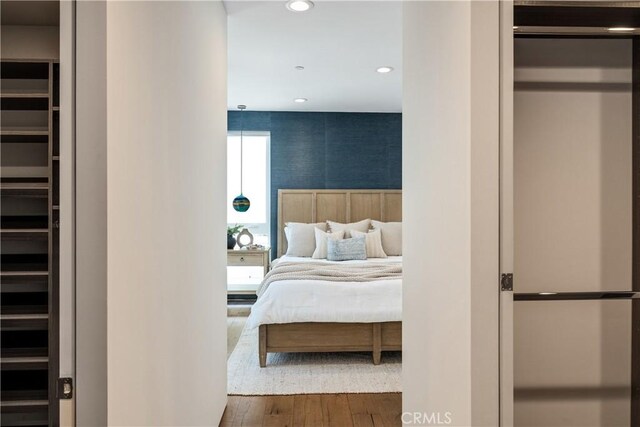 bedroom with recessed lighting and wood finished floors