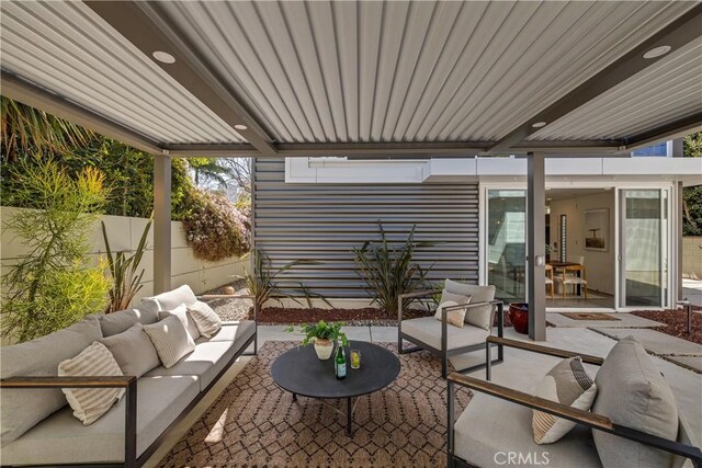 view of patio featuring fence and an outdoor hangout area