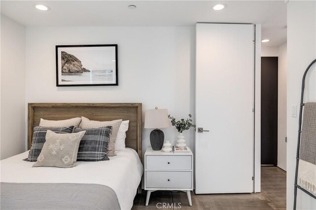 bedroom featuring wood finished floors and recessed lighting