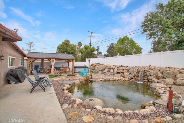 view of yard featuring a patio area, a fenced backyard, a fire pit, and a gazebo