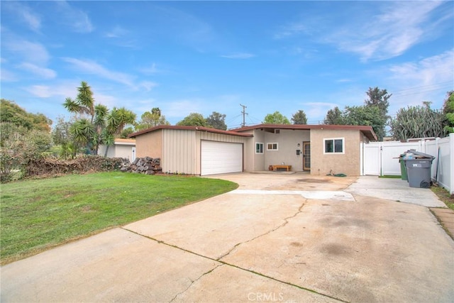 ranch-style home featuring a garage, fence, concrete driveway, a gate, and a front lawn