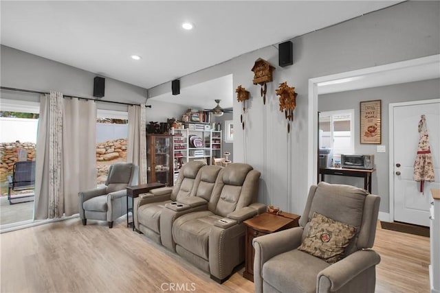 living area with light wood-style floors and recessed lighting